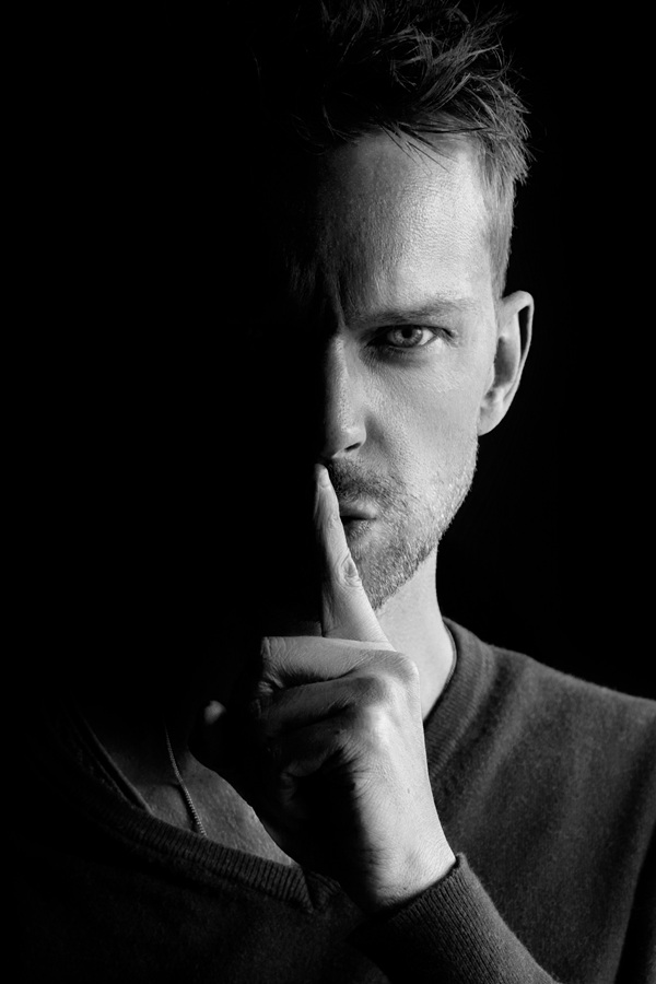 Man holding a finger to his lips