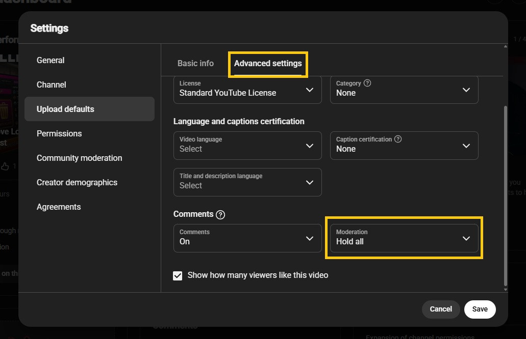 YouTube Studio's Upload defaults on the Advanced settings tab, with comment Moderation set to Hold all