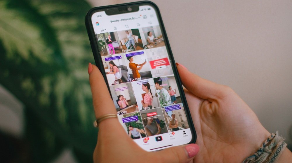 A TikTok profile grid open on a phone, every clip on it covered by the policy