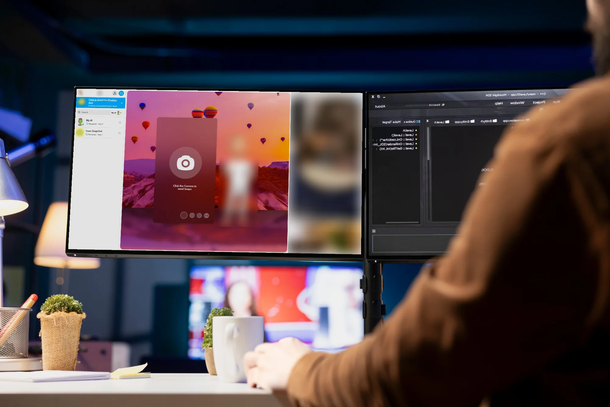 A monitor on a desk at night showing Snapchat for the web